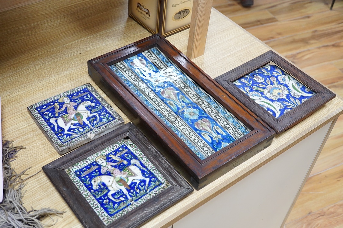 Four 18th/19th century Persian tiles, two depicting horses and riders and abstract flowers, three framed, largest 40 x 21cm